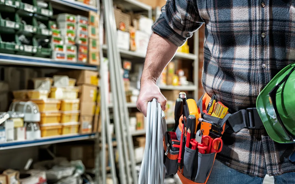A tradesman with a tool bag in a tool store