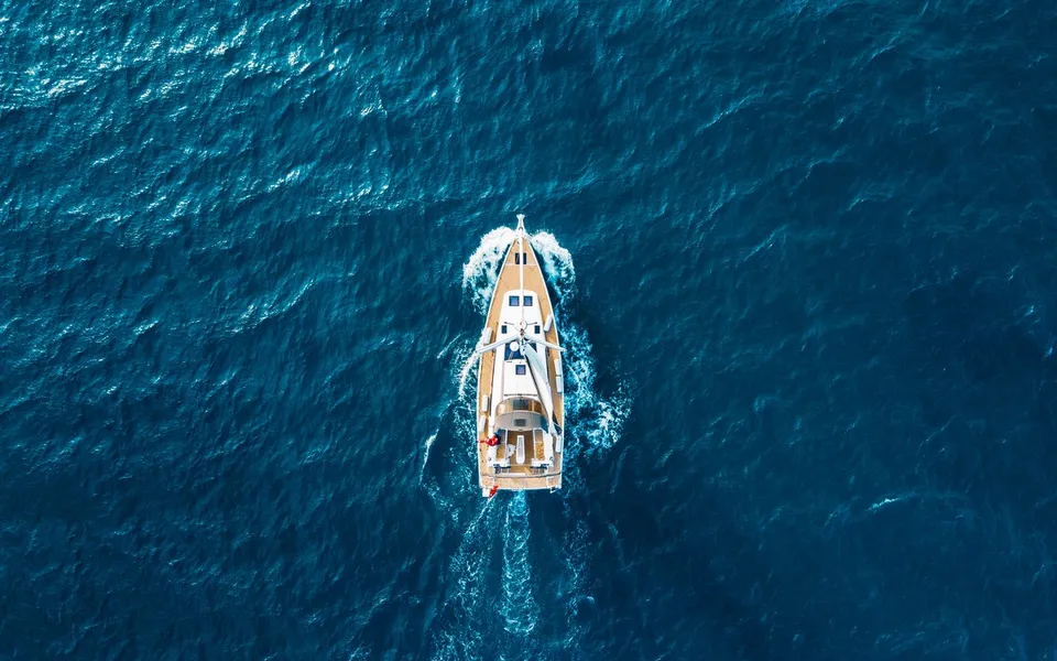 Aerial view of a yacht on blue sea
